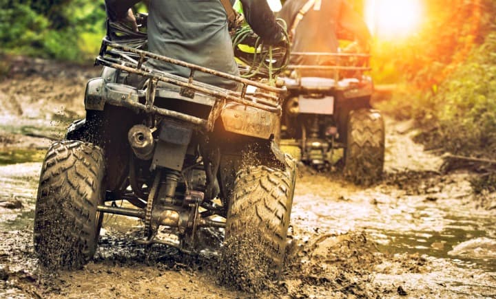 ATVs going through mud.