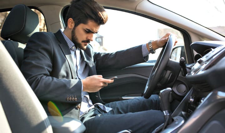 man texting in car
